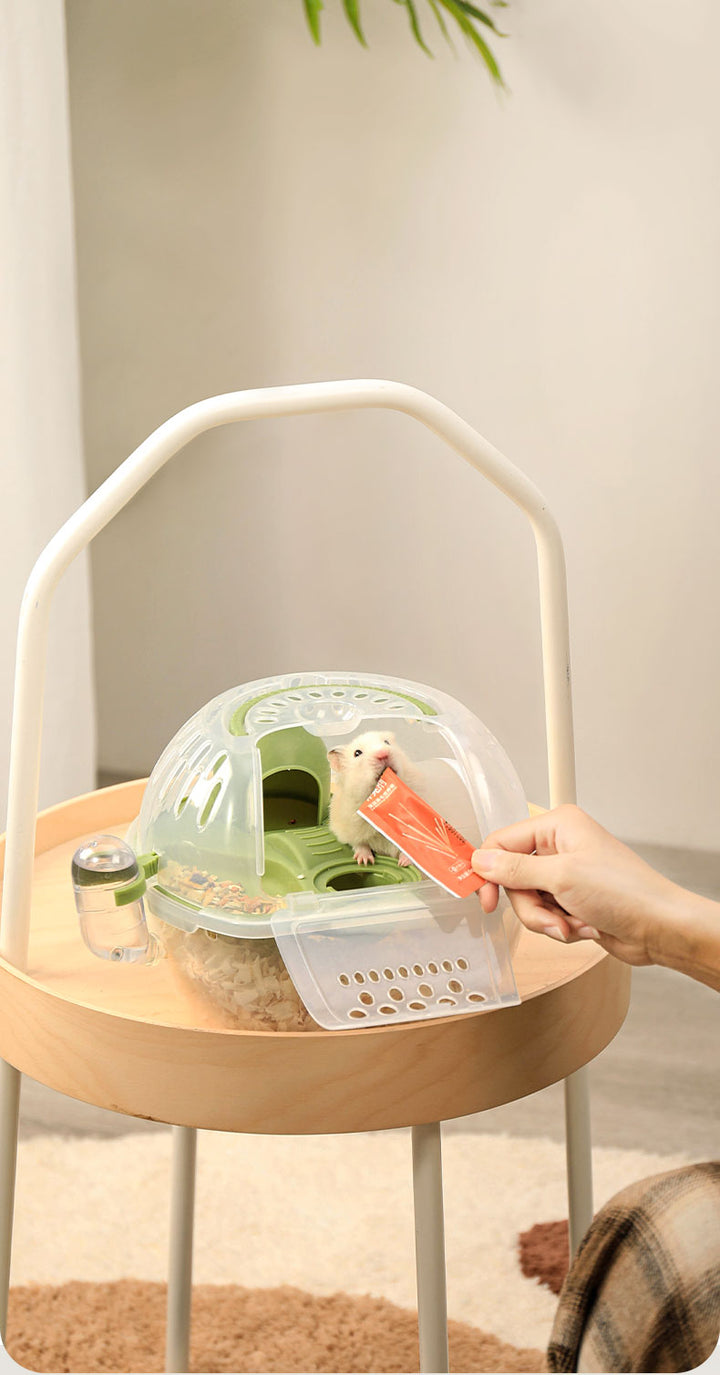 Hamster enjoying the Crystal Tote Cage during an outdoor adventure